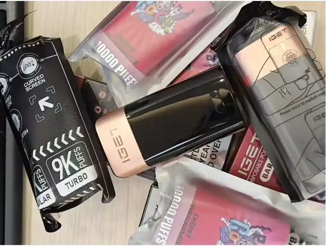 Collection of IGET disposable vape devices with retail packaging on display